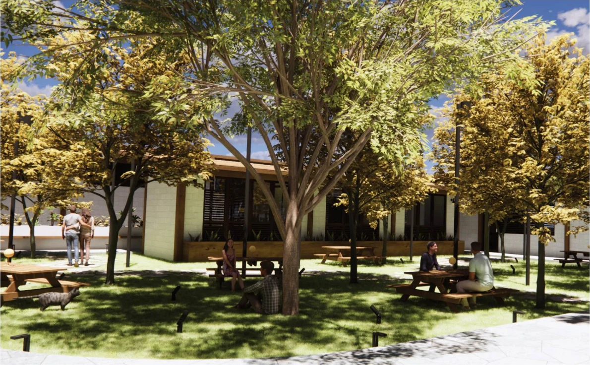 Trees shade the courtyard and community gathering spaces of the Atelier School