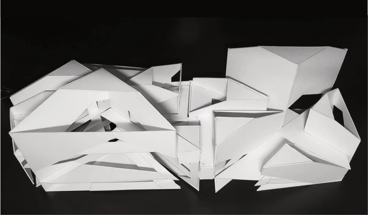 A white physical model of angular volumes and intersecting spatial planes against a black background